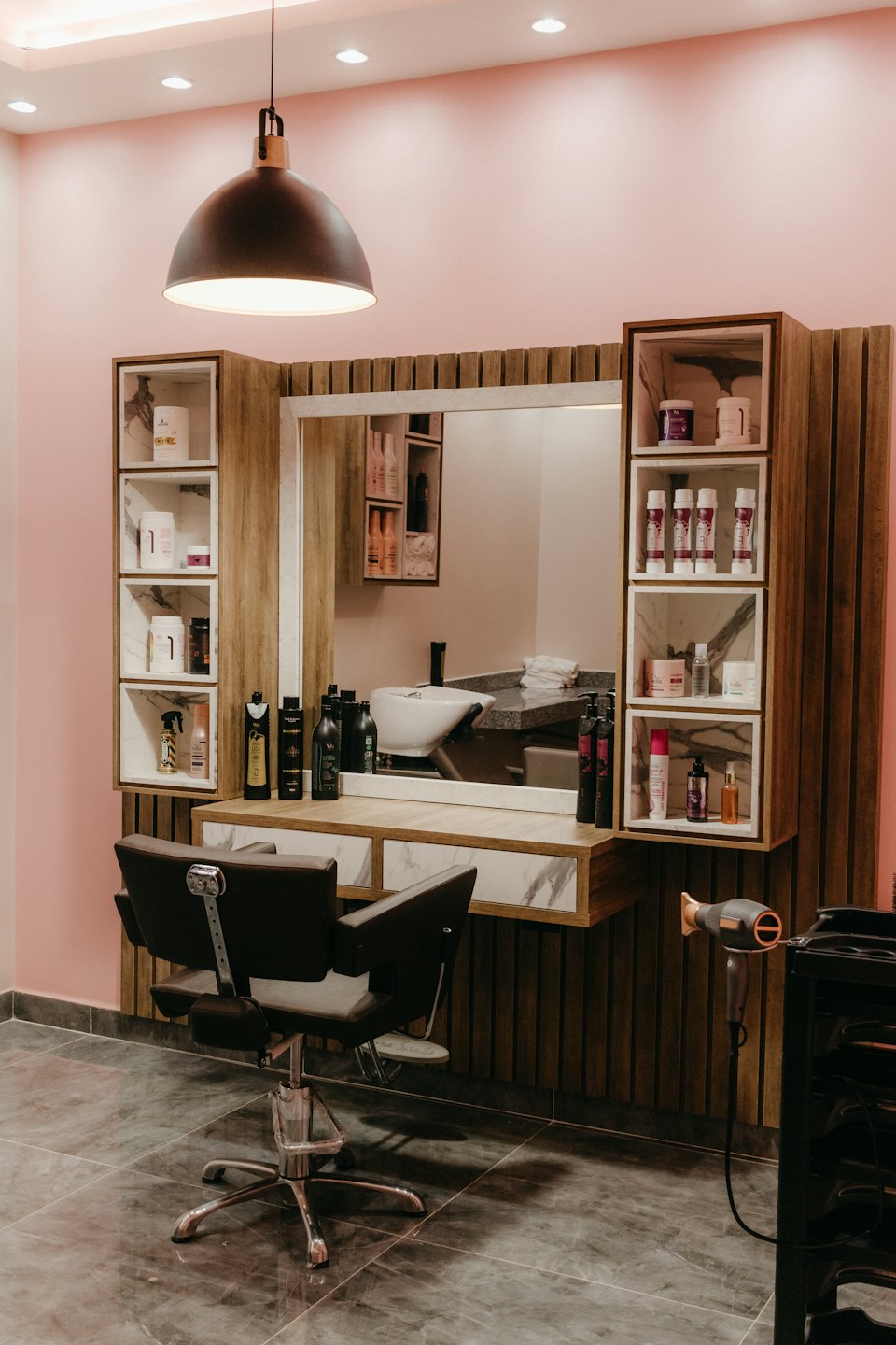 Modern styling station with a mirror and chair in a salon.
